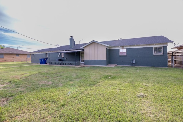 1212 S Main St, Kingfisher, OK 73750 - rear view of property with a chimney