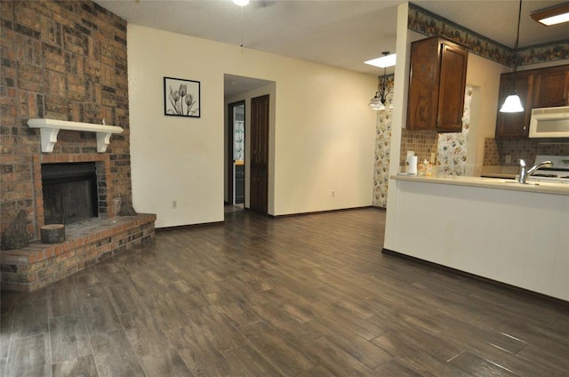 1333 SW 95th St, Oklahoma City, OK 73159 - kitchen featuring white microwave, dark wood-type flooring, backsplash, and light countertops