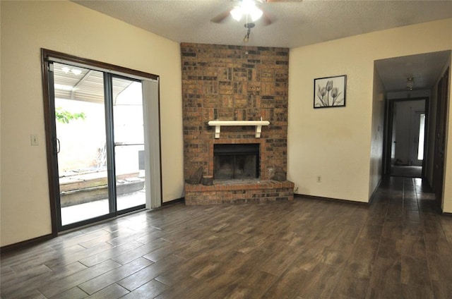1333 SW 95th St, Oklahoma City, OK 73159 - unfurnished living room featuring ceiling fan, dark wood-style flooring, a textured ceiling, and a brick fireplace