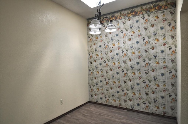 1333 SW 95th St, Oklahoma City, OK 73159 - spare room with a chandelier and dark wood-style flooring