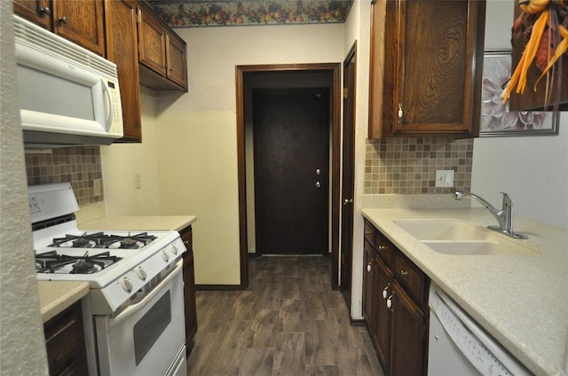 1333 SW 95th St, Oklahoma City, OK 73159 - kitchen featuring white appliances, backsplash, dark wood finished floors, and light countertops