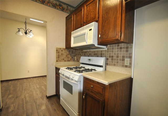 1333 SW 95th St, Oklahoma City, OK 73159 - kitchen featuring white appliances, tasteful backsplash, light countertops, and dark wood-style flooring
