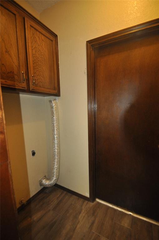 1333 SW 95th St, Oklahoma City, OK 73159 - laundry area with electric dryer hookup, cabinet space, and dark wood-style floors