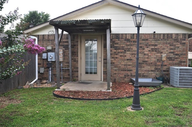 1333 SW 95th St, Oklahoma City, OK 73159 - doorway to property featuring a yard and brick siding