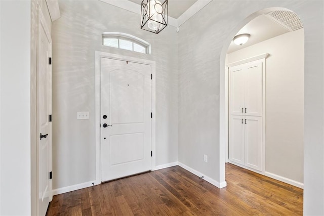 28 143rd St, Oklahoma City, OK 73170 - foyer featuring dark wood finished floors, arched walkways, and a chandelier