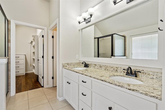 28 143rd St, Oklahoma City, OK 73170 - full bathroom with a shower stall, double vanity, tile patterned flooring, and a closet