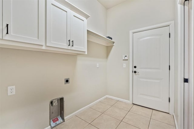 28 143rd St, Oklahoma City, OK 73170 - washroom with hookup for an electric dryer, cabinet space, and light tile patterned floors