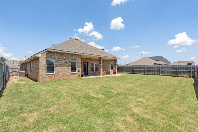 28 143rd St, Oklahoma City, OK 73170 - back of property featuring a fenced backyard, a patio area, brick siding, and roof with shingles