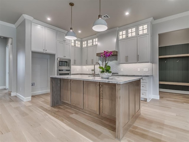 6104 NW 147th Ter, Oklahoma City, OK 73142 - kitchen featuring stainless steel appliances, backsplash, custom range hood, light wood finished floors, and ornamental molding