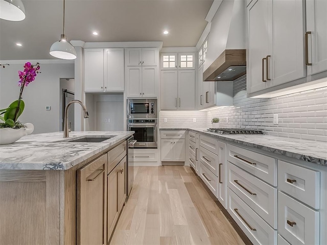 6104 NW 147th Ter, Oklahoma City, OK 73142 - kitchen with stainless steel appliances, custom exhaust hood, light wood-style flooring, decorative backsplash, and light stone counters