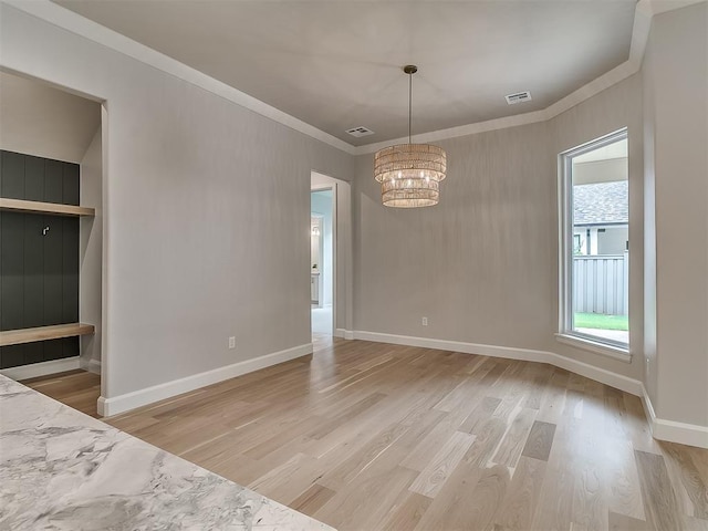 6104 NW 147th Ter, Oklahoma City, OK 73142 - unfurnished dining area featuring a chandelier, light wood-type flooring, and ornamental molding