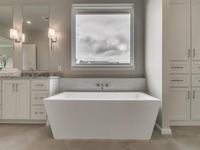 6104 NW 147th Ter, Oklahoma City, OK 73142 - full bath featuring tile patterned floors, a soaking tub, and vanity