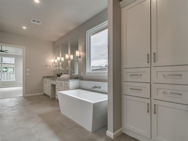6104 NW 147th Ter, Oklahoma City, OK 73142 - full bathroom with vanity, a freestanding bath, recessed lighting, and ceiling fan