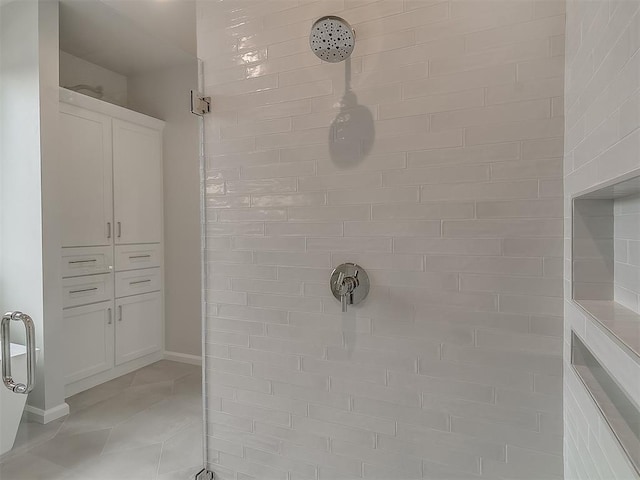 6104 NW 147th Ter, Oklahoma City, OK 73142 - bathroom featuring tiled shower and tile patterned flooring