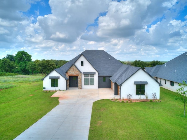 2261 Winter Creek Blvd, Blanchard, OK 73010 - modern farmhouse style home featuring driveway, a front yard, stucco siding, stone siding, and roof with shingles