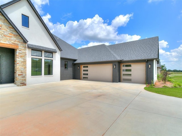 2261 Winter Creek Blvd, Blanchard, OK 73010 - view of front facade featuring stucco siding, driveway, an attached garage, roof with shingles, and stone siding