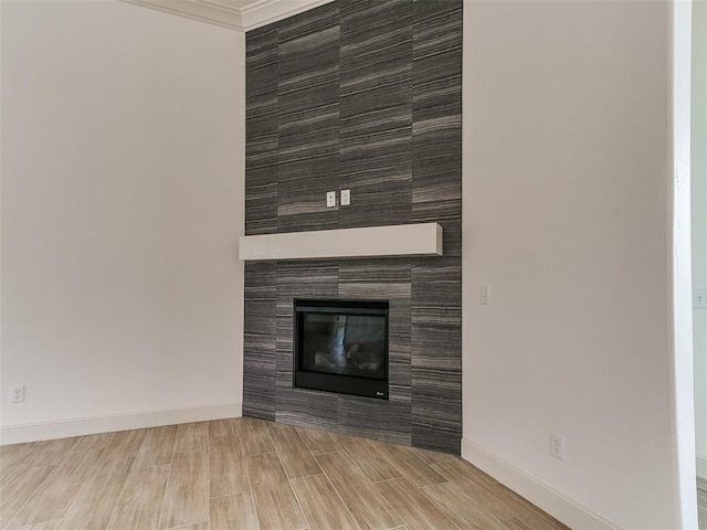 2261 Winter Creek Blvd, Blanchard, OK 73010 - unfurnished living room with a tile fireplace, crown molding, and wood tiled floors