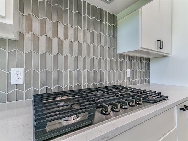 2261 Winter Creek Blvd, Blanchard, OK 73010 - kitchen view of stainless steel gas cooktop, backsplash, and white cabinets