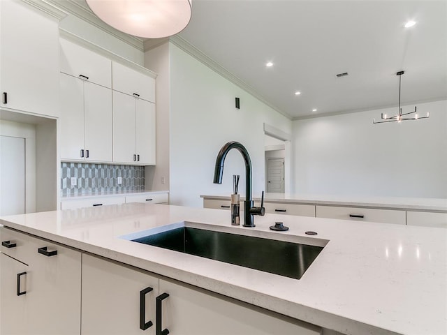2261 Winter Creek Blvd, Blanchard, OK 73010 - kitchen featuring decorative light fixtures, ornamental molding, decorative backsplash, light stone countertops, and white cabinets