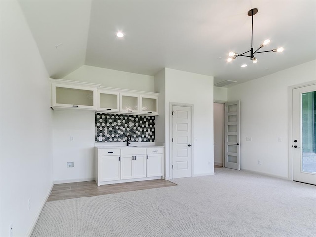 2261 Winter Creek Blvd, Blanchard, OK 73010 - bar area with a chandelier, light colored carpet, hanging light fixtures, and backsplash