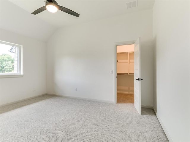 2261 Winter Creek Blvd, Blanchard, OK 73010 - unfurnished bedroom with light colored carpet, a walk in closet, lofted ceiling, a closet, and a ceiling fan