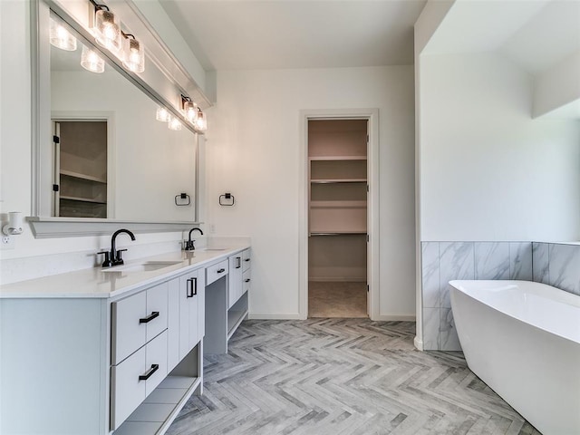 2261 Winter Creek Blvd, Blanchard, OK 73010 - bathroom featuring double vanity, a freestanding tub, and a spacious closet