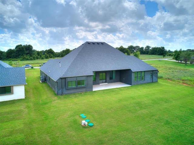 2261 Winter Creek Blvd, Blanchard, OK 73010 - rear view of house with a patio, a lawn, and roof with shingles