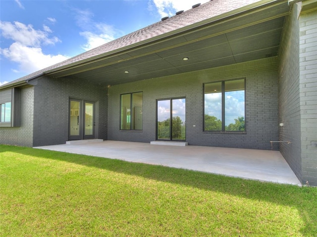 2261 Winter Creek Blvd, Blanchard, OK 73010 - back of house with a patio area, a lawn, and brick siding
