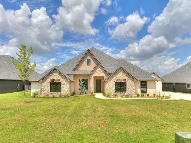 2263 Winter Creek Blvd, Blanchard, OK 73010 - french country style house featuring stone siding, a front yard, and a shingled roof