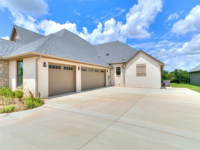 2263 Winter Creek Blvd, Blanchard, OK 73010 - view of front of home featuring a shingled roof, concrete driveway, an attached garage, and brick siding