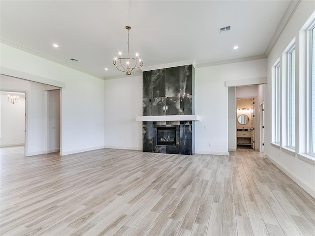 2263 Winter Creek Blvd, Blanchard, OK 73010 - unfurnished living room with a chandelier, light wood-style floors, ornamental molding, recessed lighting, and a high end fireplace