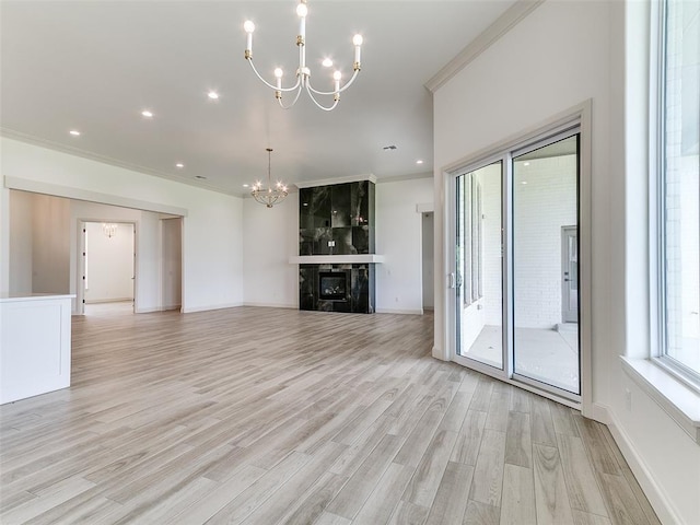 2263 Winter Creek Blvd, Blanchard, OK 73010 - unfurnished living room featuring a chandelier, light wood finished floors, ornamental molding, recessed lighting, and a large fireplace