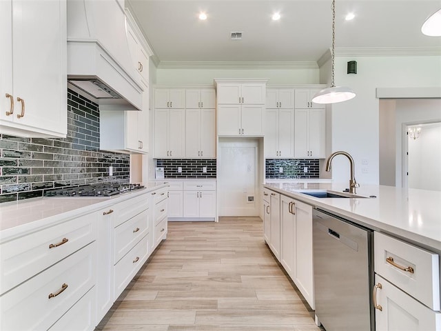 2263 Winter Creek Blvd, Blanchard, OK 73010 - kitchen with appliances with stainless steel finishes, ornamental molding, light countertops, white cabinetry, and pendant lighting