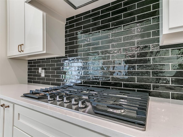 2263 Winter Creek Blvd, Blanchard, OK 73010 - kitchen featuring stainless steel gas stovetop, white cabinets, backsplash, and light countertops