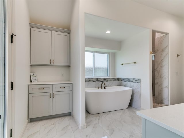 2263 Winter Creek Blvd, Blanchard, OK 73010 - bathroom with marble finish flooring, a freestanding bath, a marble finish shower, vanity, and recessed lighting