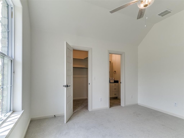 2263 Winter Creek Blvd, Blanchard, OK 73010 - unfurnished bedroom with light carpet, lofted ceiling, a spacious closet, connected bathroom, and ceiling fan