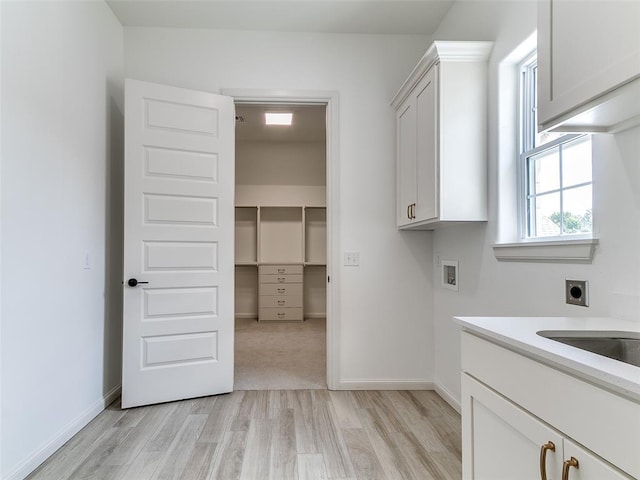2263 Winter Creek Blvd, Blanchard, OK 73010 - laundry room featuring hookup for an electric dryer, light wood-style floors, hookup for a washing machine, and cabinet space