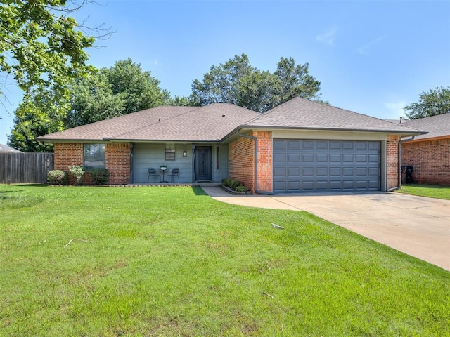 313 Ember Glow Dr, Moore, OK 73160 - ranch-style house featuring an attached garage, driveway, and brick siding