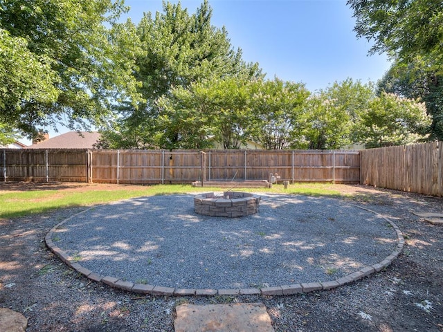 313 Ember Glow Dr, Moore, OK 73160 - fenced backyard with an outdoor fire pit