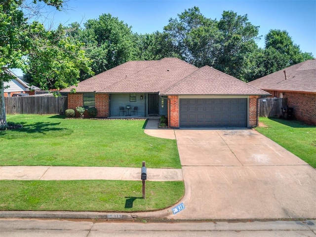 313 Ember Glow Dr, Moore, OK 73160 - single story home featuring a garage, driveway, brick siding, and a shingled roof