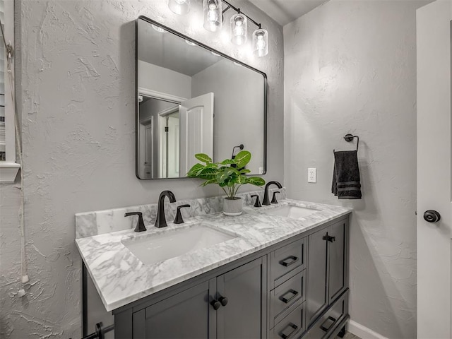 313 Ember Glow Dr, Moore, OK 73160 - bathroom with double vanity and a textured wall