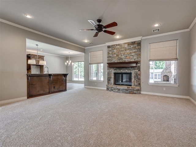 1233 Autumn Creek Dr, Edmond, OK 73003 - unfurnished living room featuring ornamental molding, recessed lighting, light colored carpet, ceiling fan, and a fireplace