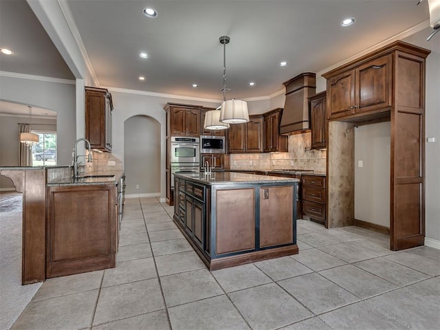 1233 Autumn Creek Dr, Edmond, OK 73003 - kitchen with stainless steel appliances, stone counters, arched walkways, backsplash, and recessed lighting