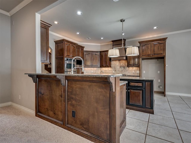 1233 Autumn Creek Dr, Edmond, OK 73003 - kitchen with stone countertops, decorative backsplash, a breakfast bar, ornamental molding, and a peninsula