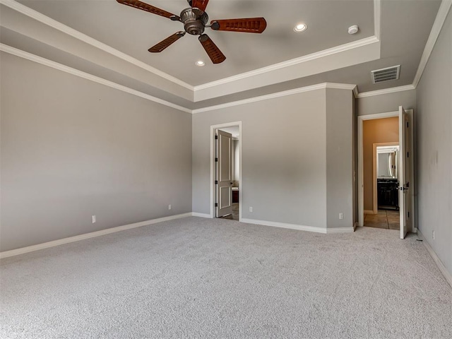 1233 Autumn Creek Dr, Edmond, OK 73003 - unfurnished bedroom featuring a tray ceiling, light carpet, recessed lighting, ornamental molding, and ceiling fan