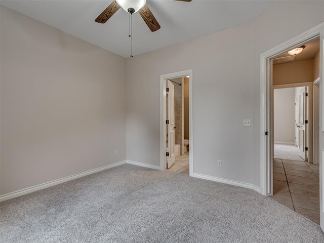 1233 Autumn Creek Dr, Edmond, OK 73003 - unfurnished bedroom with light colored carpet, ensuite bathroom, a ceiling fan, and light tile patterned floors
