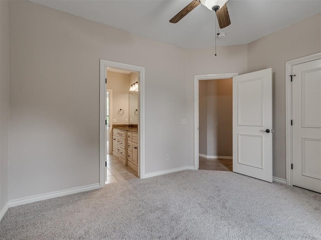 1233 Autumn Creek Dr, Edmond, OK 73003 - unfurnished bedroom with light carpet, ensuite bath, light tile patterned flooring, and a ceiling fan