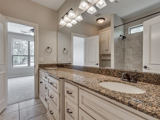 1233 Autumn Creek Dr, Edmond, OK 73003 - full bathroom featuring double vanity, a tile shower, and tile patterned floors