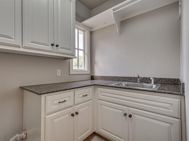 1233 Autumn Creek Dr, Edmond, OK 73003 - kitchen featuring dark countertops and white cabinets
