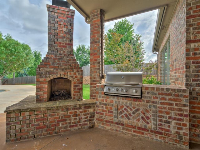1233 Autumn Creek Dr, Edmond, OK 73003 - view of patio featuring an outdoor brick fireplace and exterior kitchen